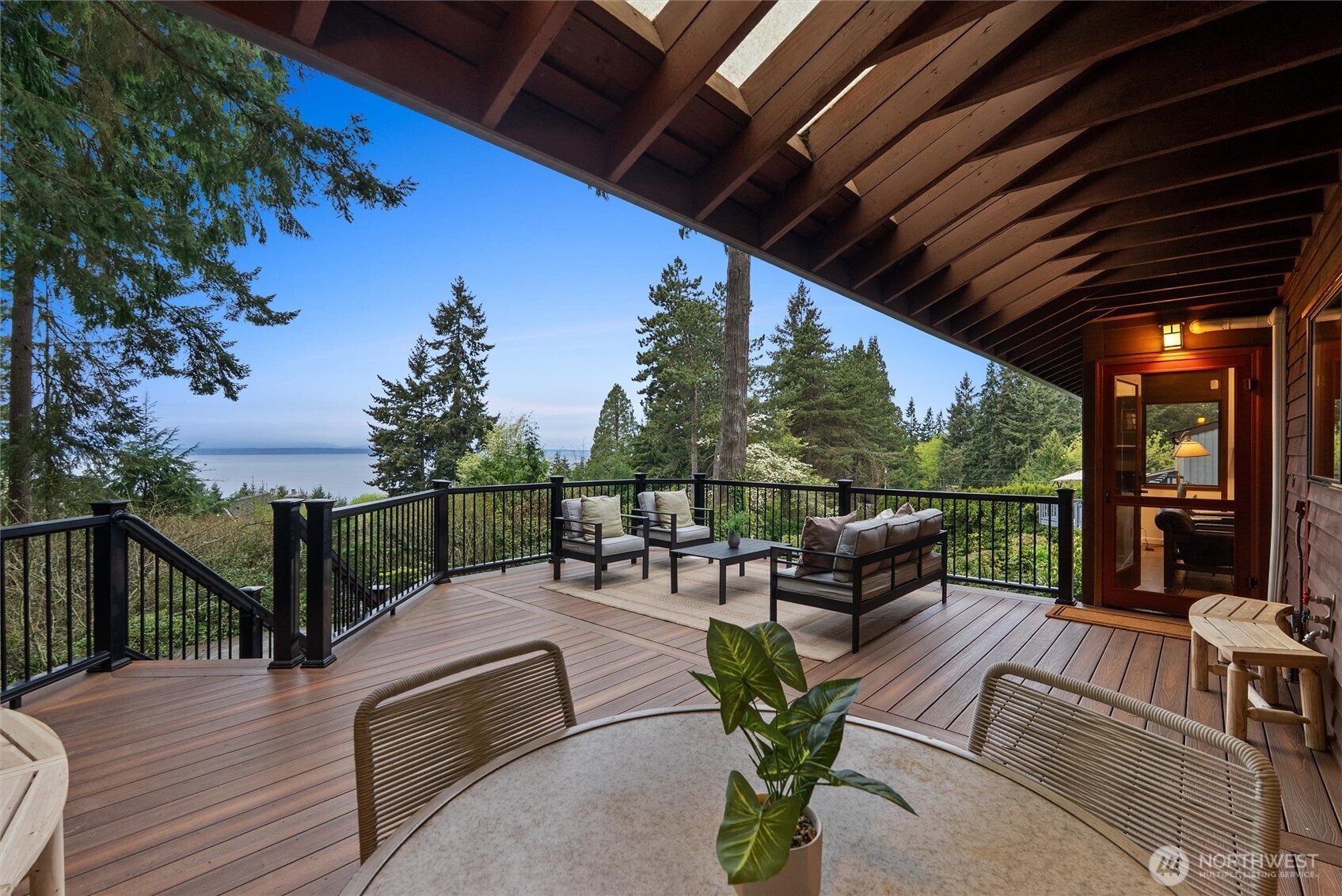 6920 160th Street Southwest Edmonds, WA 98026 - Photo 9 of 40 a view of a patio with couches table and chairs with wooden floor and fence