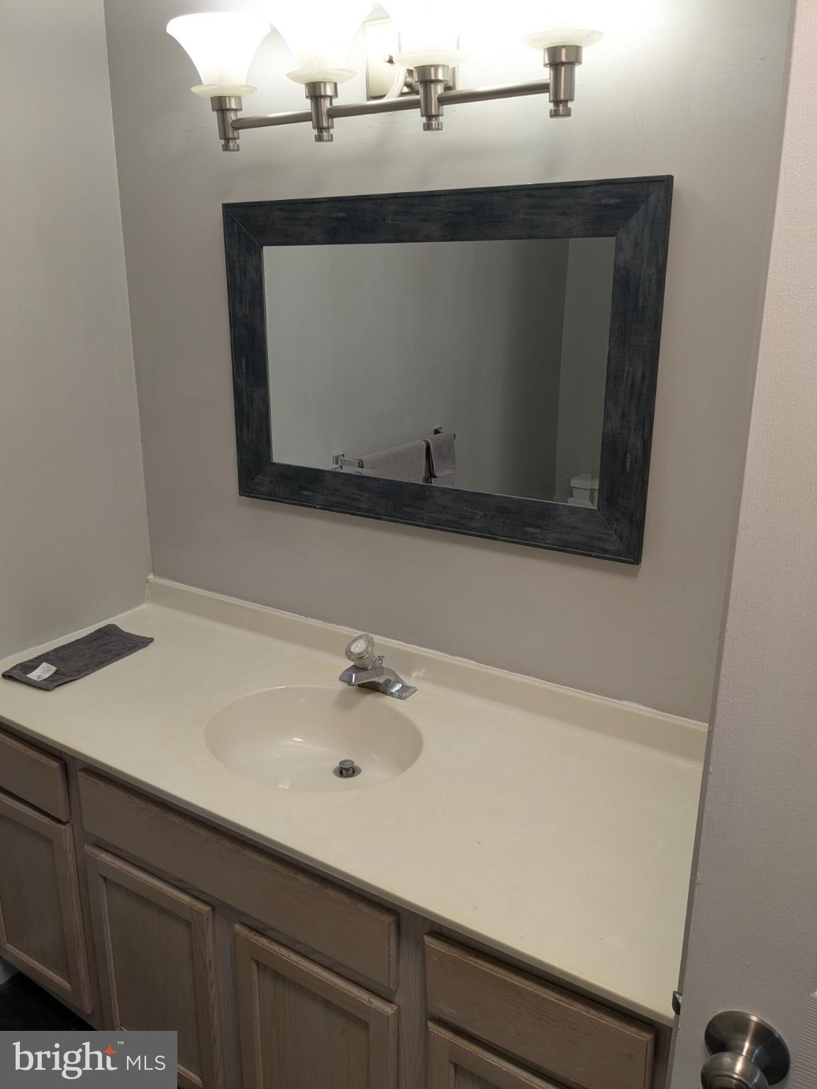 25 Millstream Road Pine Hill, NJ 08021 - Photo 21 of 28 a bathroom with a sink and a mirror