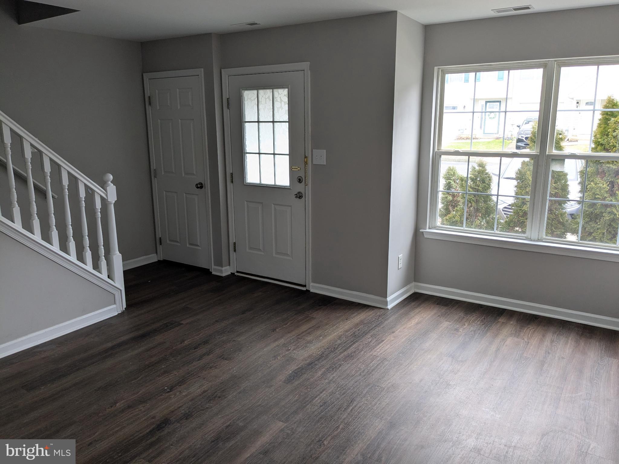 25 Millstream Road Pine Hill, NJ 08021 - Photo 3 of 28 a view of an empty room with wooden floor and a window