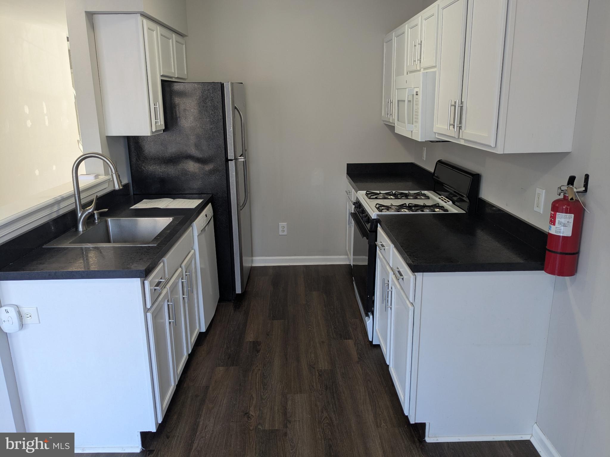 25 Millstream Road Pine Hill, NJ 08021 - Photo 4 of 28 a kitchen with a sink stove and cabinets