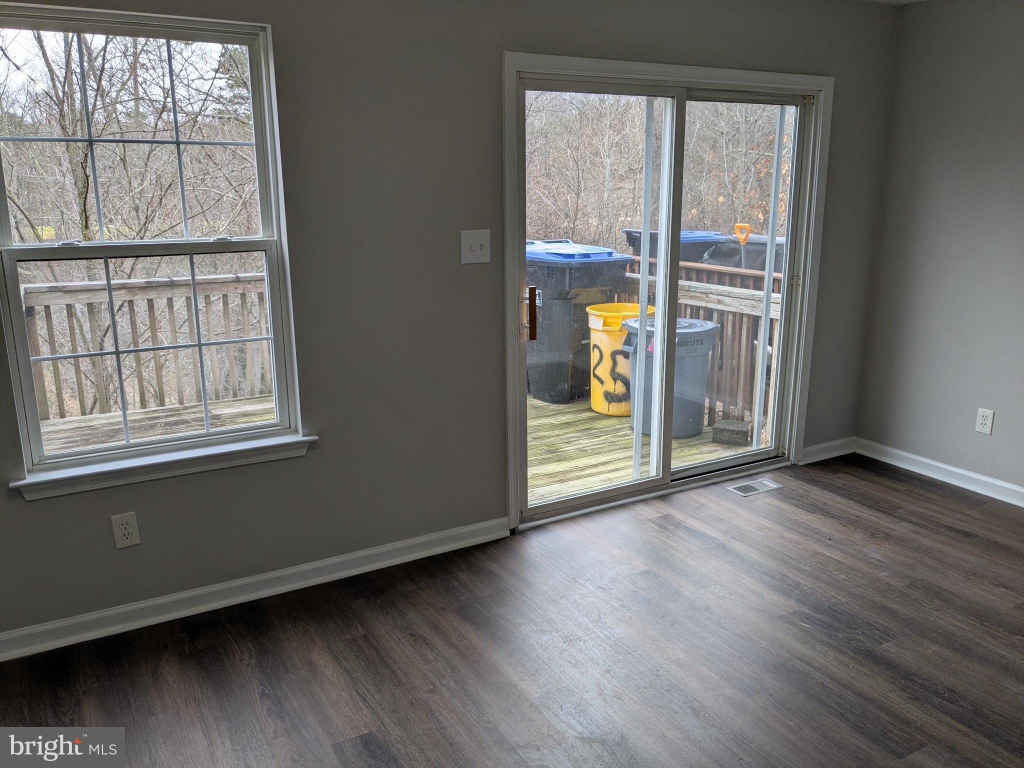 25 Millstream Road Pine Hill, NJ 08021 - Photo 7 of 28 an empty room with wooden floor and windows