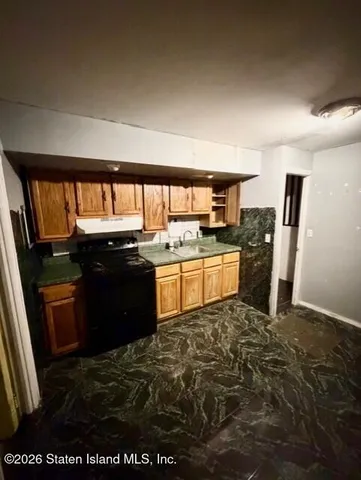 a white toilet sitting next to a bathroom sink and a shower