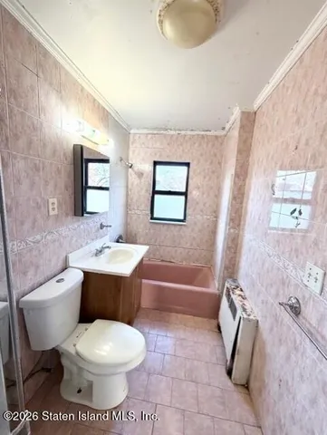 a view of a livingroom with wooden floor and window
