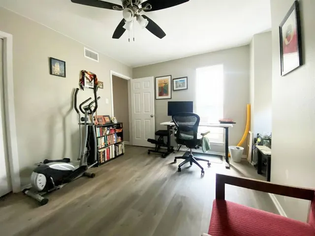 a view of a livingroom with workspace and a window