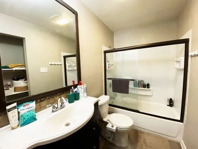 a bedroom with a bed and a mirror