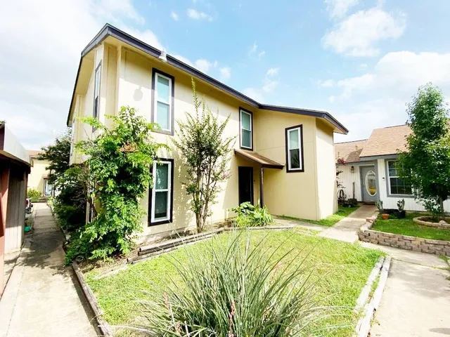 a front view of a house with a yard