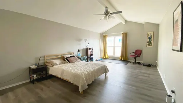 a bedroom with furniture and a wooden floor