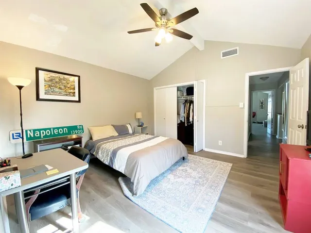 a bedroom with a bed and wooden floor