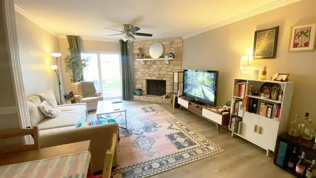 a living room with furniture flat screen tv and a fireplace
