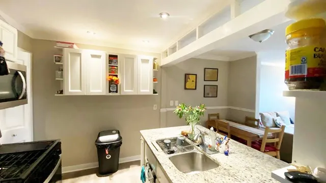 a kitchen with a sink and a stove top oven