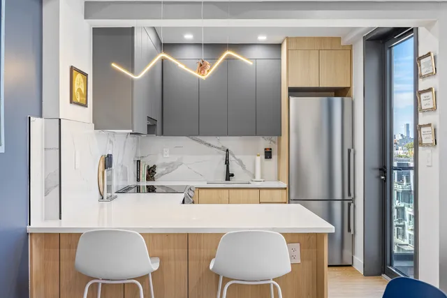 a living room with furniture a couch and paintings on the wall
