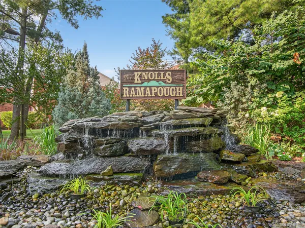 a view of a house with a yard and potted plants