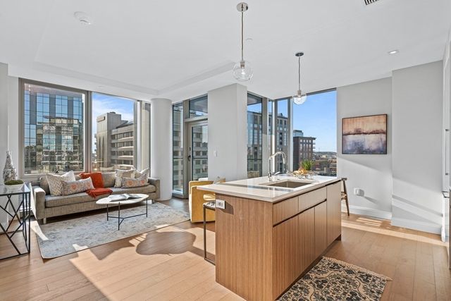 a view of kitchen with stainless steel appliances granite countertop sink stove and wooden floor