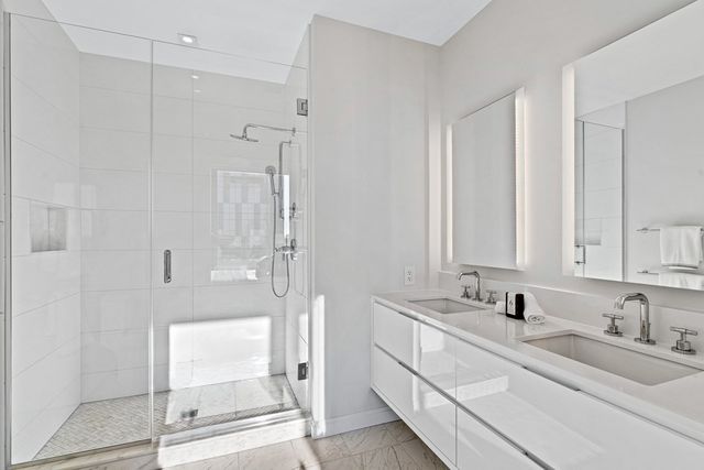 a bathroom with a double vanity sink mirror and double