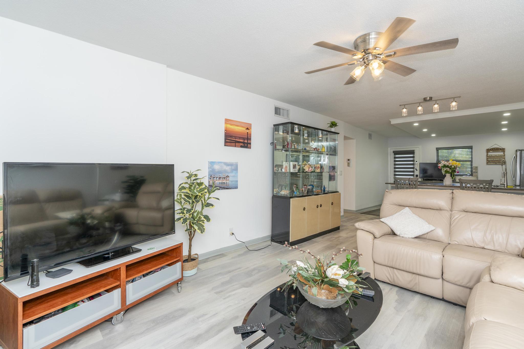 2600 Northeast 1st Lane, Unit 104 Boynton Beach, FL 33435 - Photo 12 of 41 a living room with furniture and a flat screen tv
