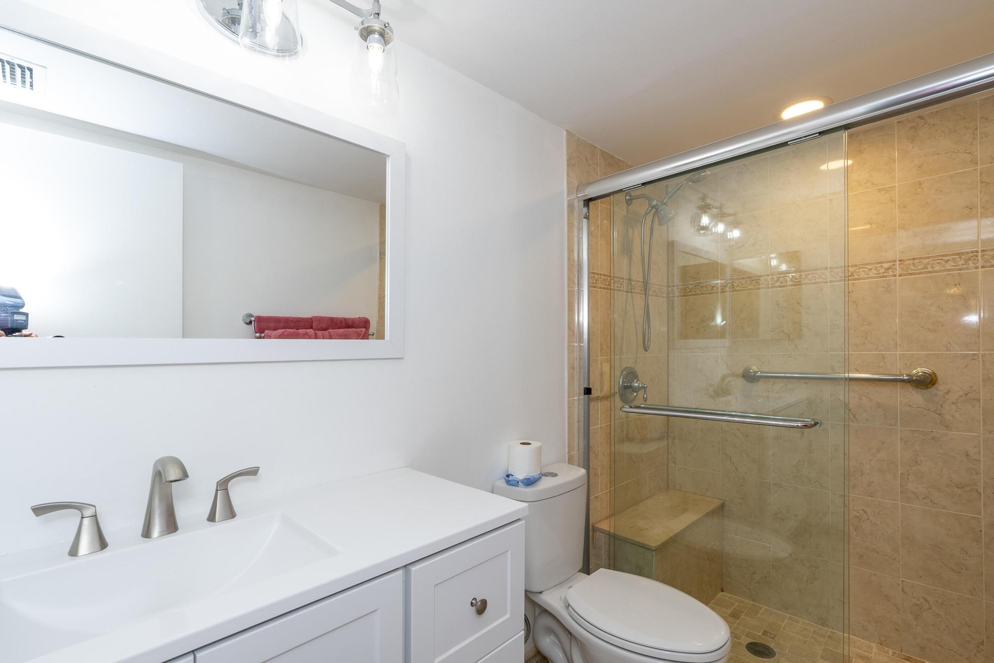 2600 Northeast 1st Lane, Unit 104 Boynton Beach, FL 33435 - Photo 19 of 41 a bathroom with a sink mirror vanity and toilet