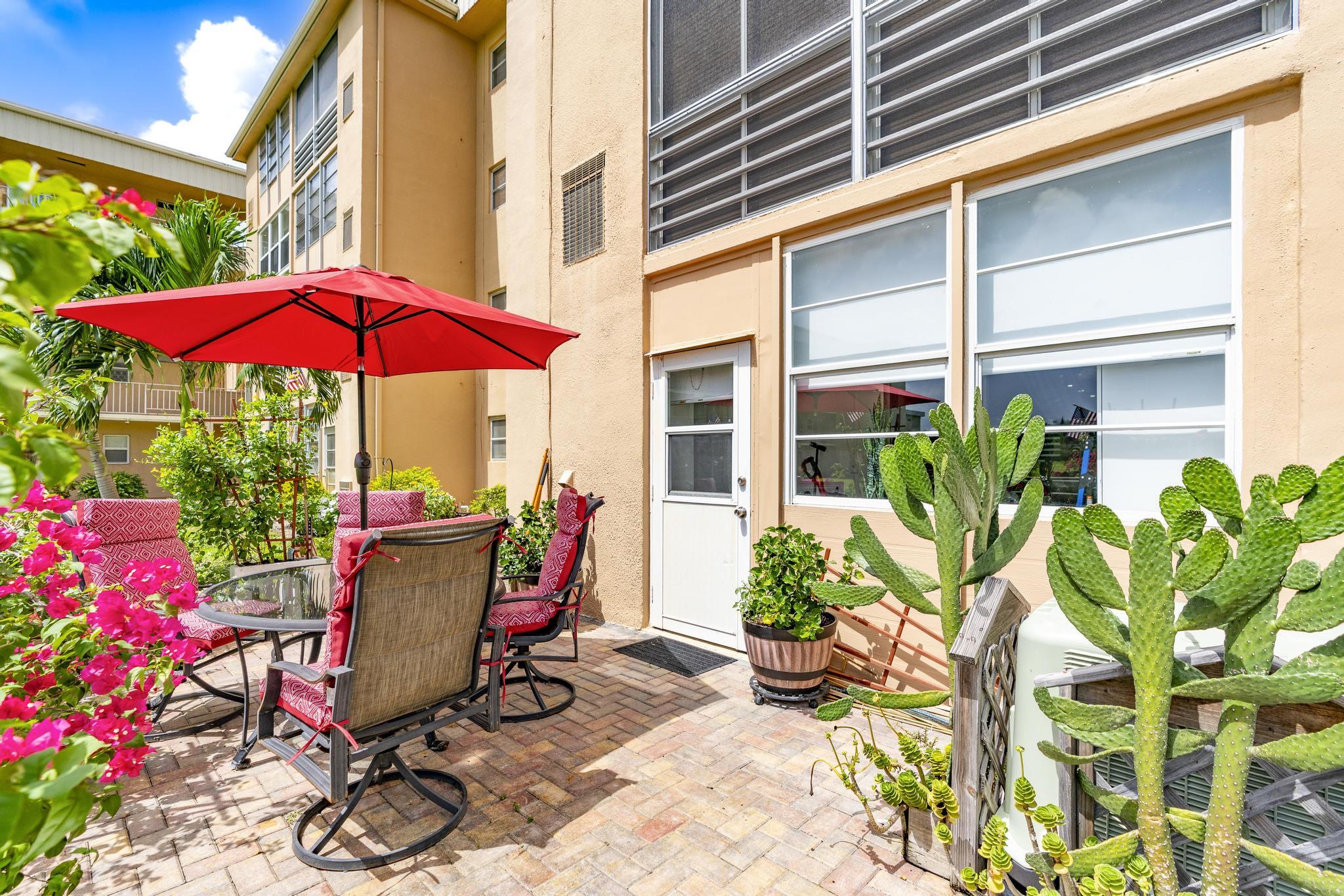 2600 Northeast 1st Lane, Unit 104 Boynton Beach, FL 33435 - Photo 27 of 41 a view of a chairs and table in the patio