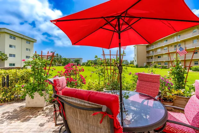 a view of a chairs and table in patio with a fire pit