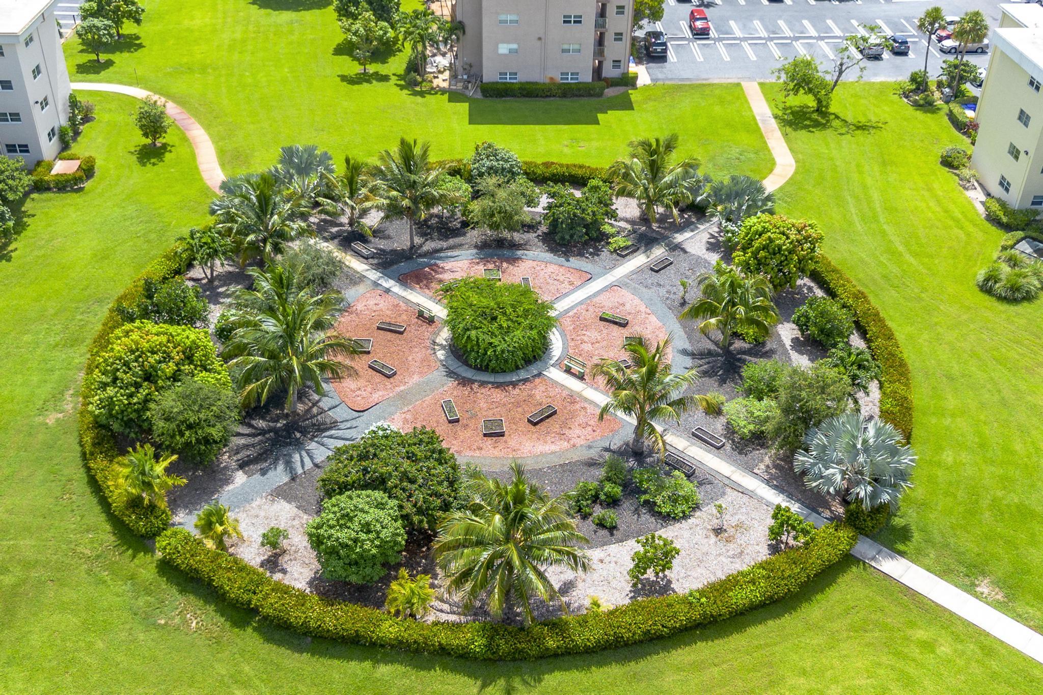 2600 Northeast 1st Lane, Unit 104 Boynton Beach, FL 33435 - Photo 34 of 41 a view of a swimming pool with a yard
