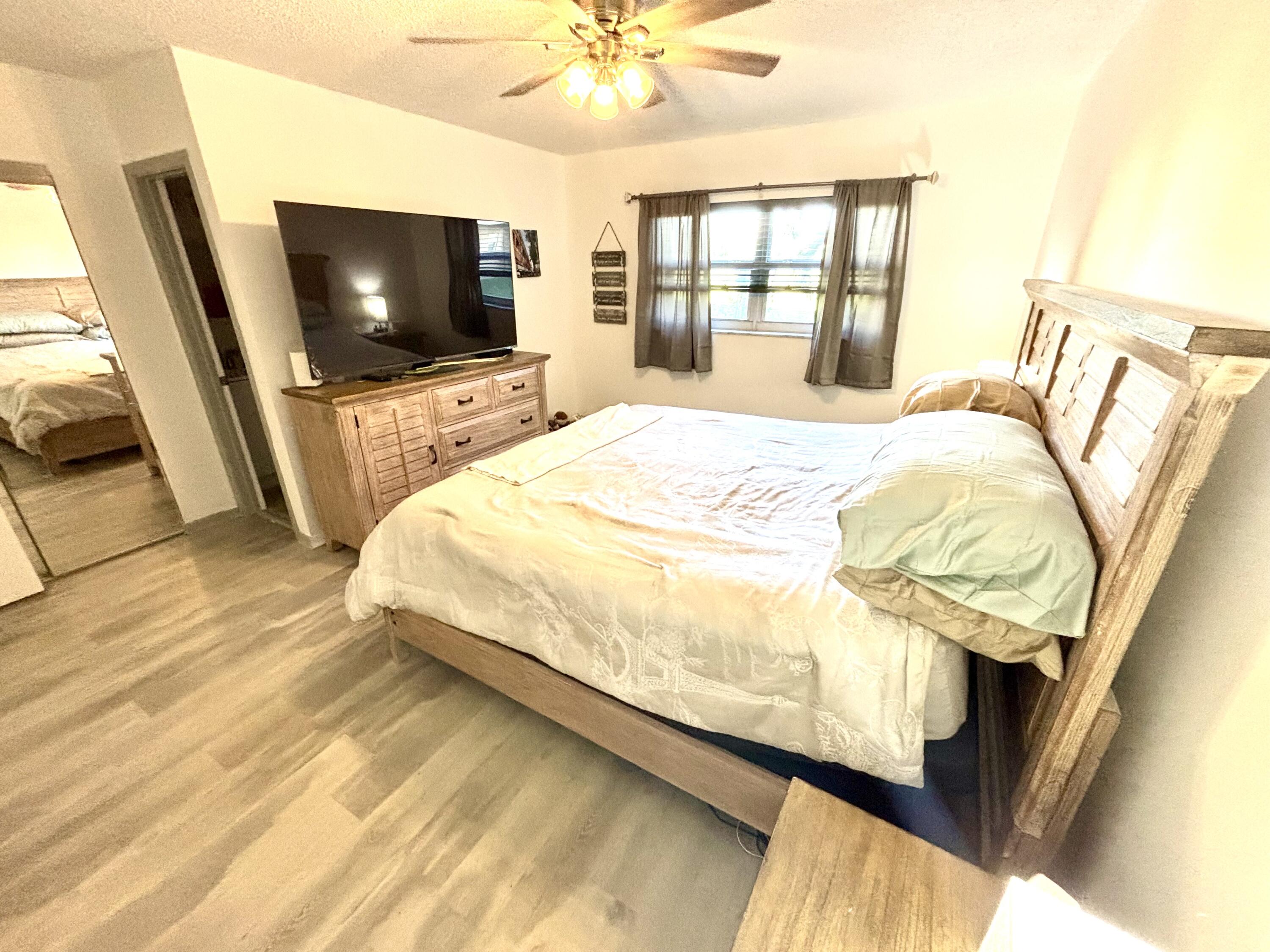 2600 Northeast 1st Lane, Unit 104 Boynton Beach, FL 33435 - Photo 41 of 41 a bedroom with a bed and a flat screen tv