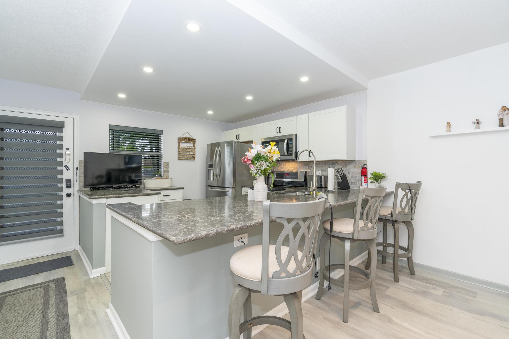 2600 Northeast 1st Lane, Unit 104 Boynton Beach, FL 33435 - Photo 6 of 41 a large kitchen with a table and chairs