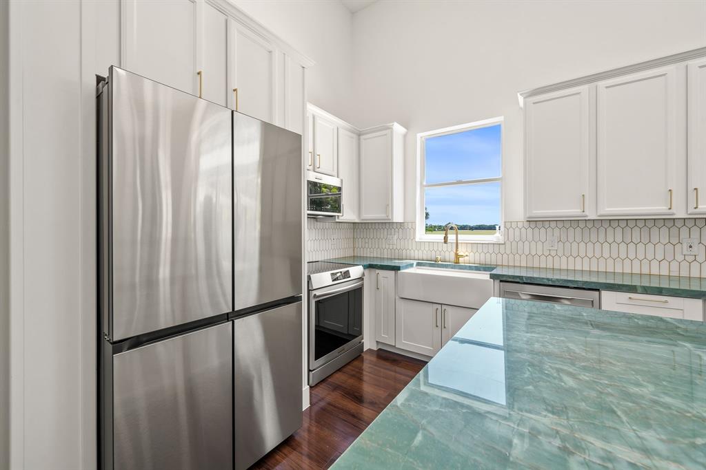 3950 Fieldview Way Wellington, FL 33414 - Photo 15 of 29 a kitchen with stainless steel appliances a refrigerator sink microwave and cabinets