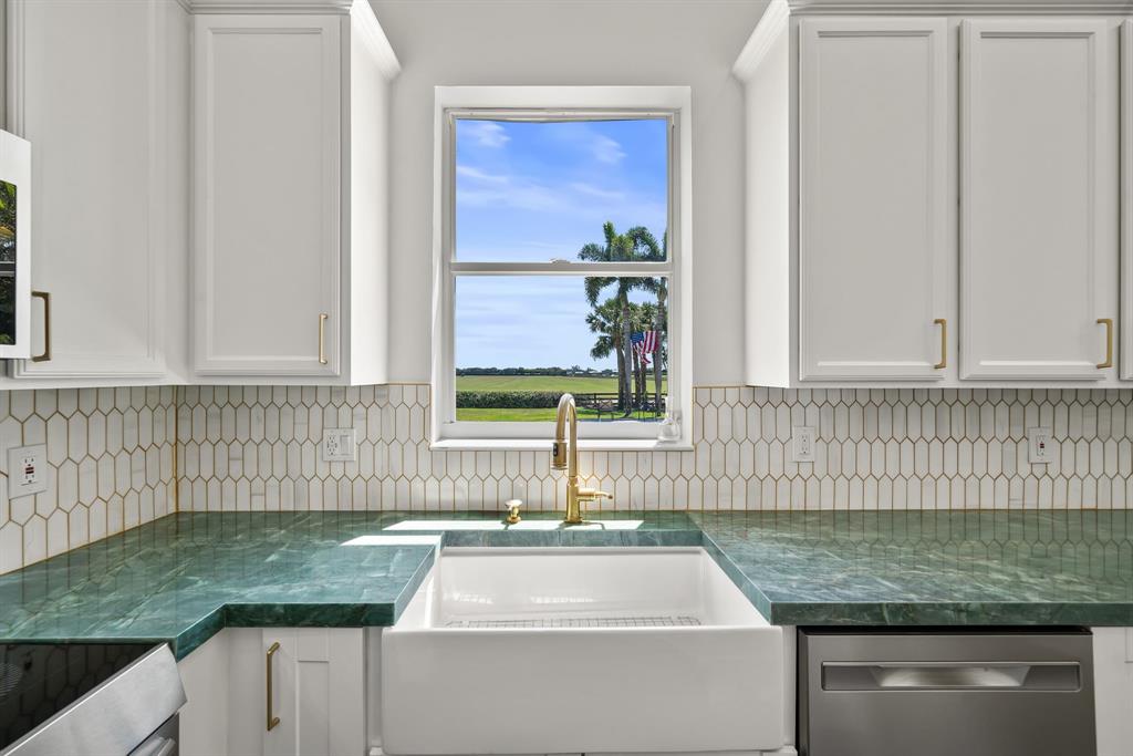 3950 Fieldview Way Wellington, FL 33414 - Photo 16 of 29 a kitchen with granite countertop a sink and a window