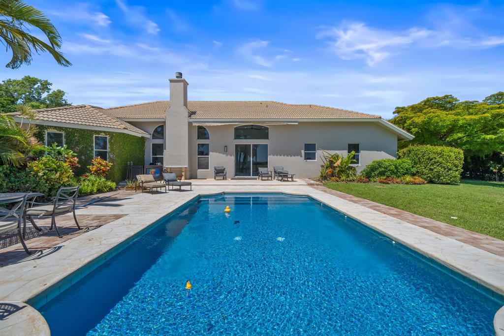 3950 Fieldview Way Wellington, FL 33414 - Photo 2 of 29 a swimming pool with outdoor seating and yard