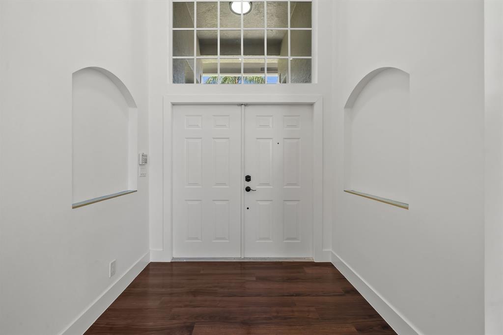3950 Fieldview Way Wellington, FL 33414 - Photo 26 of 29 a view of an empty room with wooden floor and a window