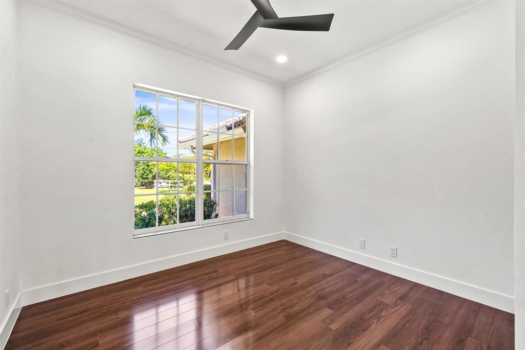 3950 Fieldview Way Wellington, FL 33414 - Photo 29 of 29 an empty room with wooden floor and windows