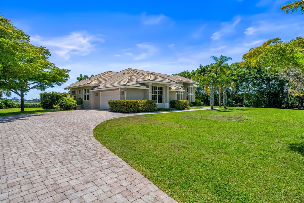 3950 Fieldview Way Wellington, FL 33414 - Photo 8 of 29 a front view of a house with a yard