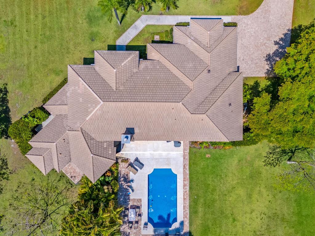 3950 Fieldview Way Wellington, FL 33414 - Photo 9 of 29 an aerial view of a house with a garden and trees all around