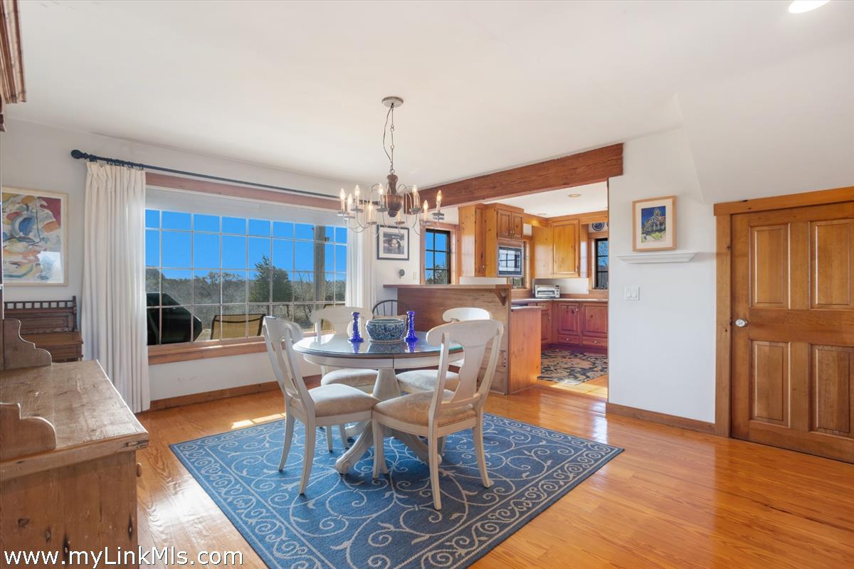13 Eat Fire Spring Road Nantucket, MA 02554 - Photo 15 of 43 a dining room with furniture a chandelier and wooden floor