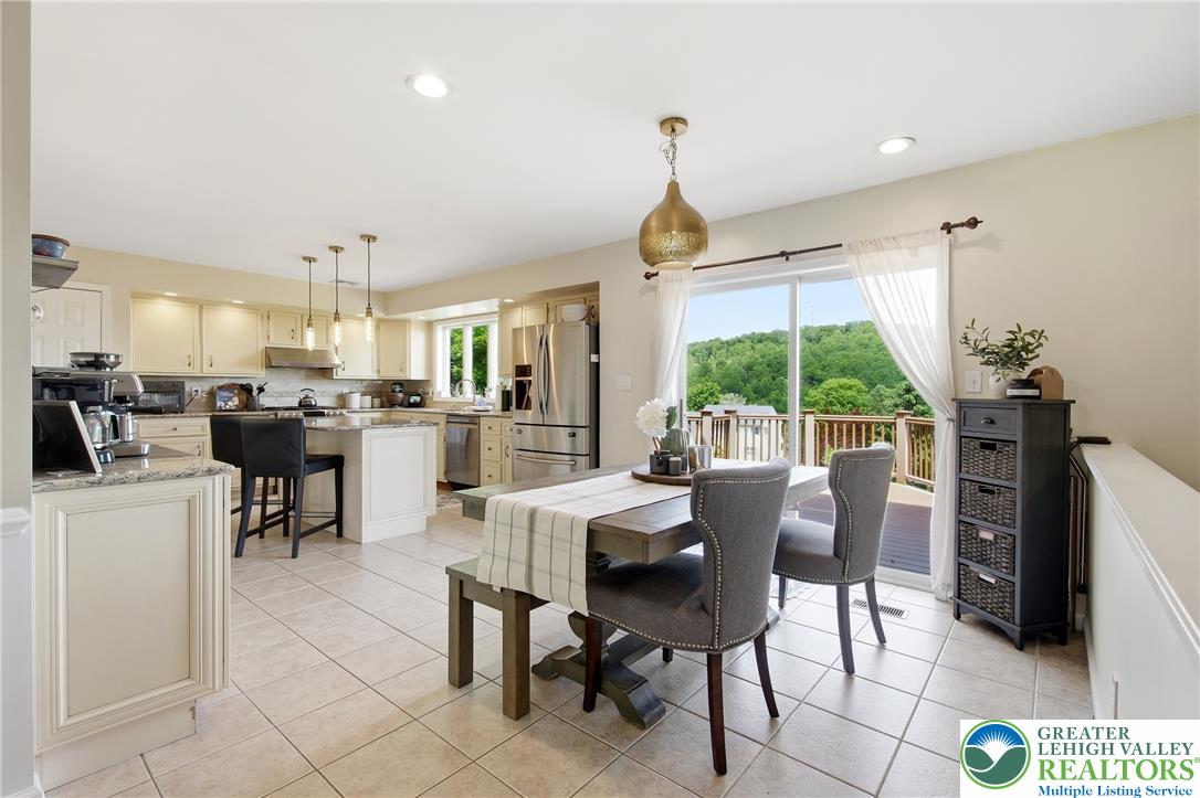 115 West Butternut Road Hellertown, PA 18055 - Photo 23 of 97 An open-concept kitchen and dining area features abundant natural light and an outdoor deck with verdant views.