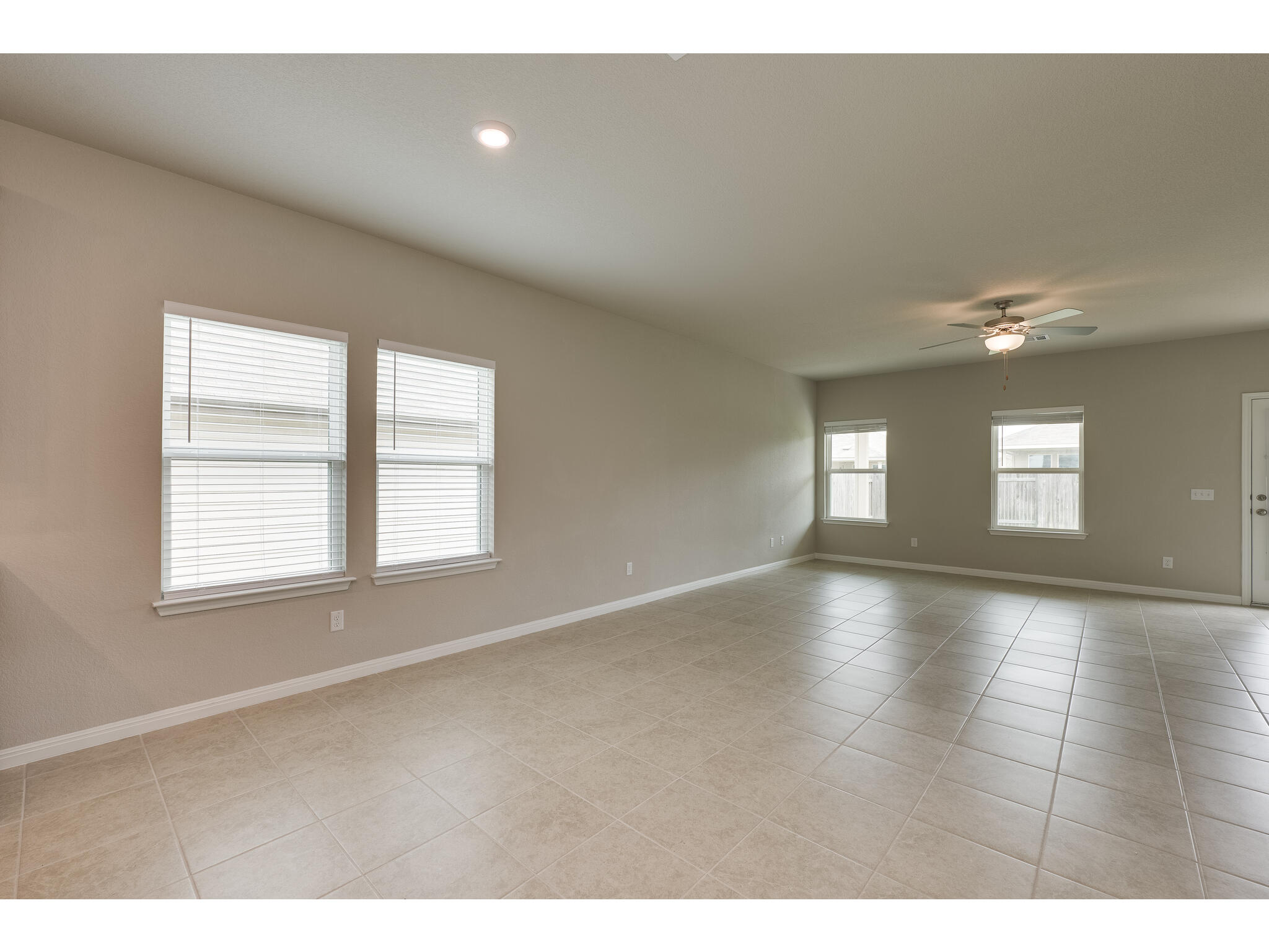 111 Grapefruit Road Hutto, TX 78634 - Photo 15 of 39 Empty room featuring baseboards, a ceiling fan, light tile patterned flooring, and recessed lighting
