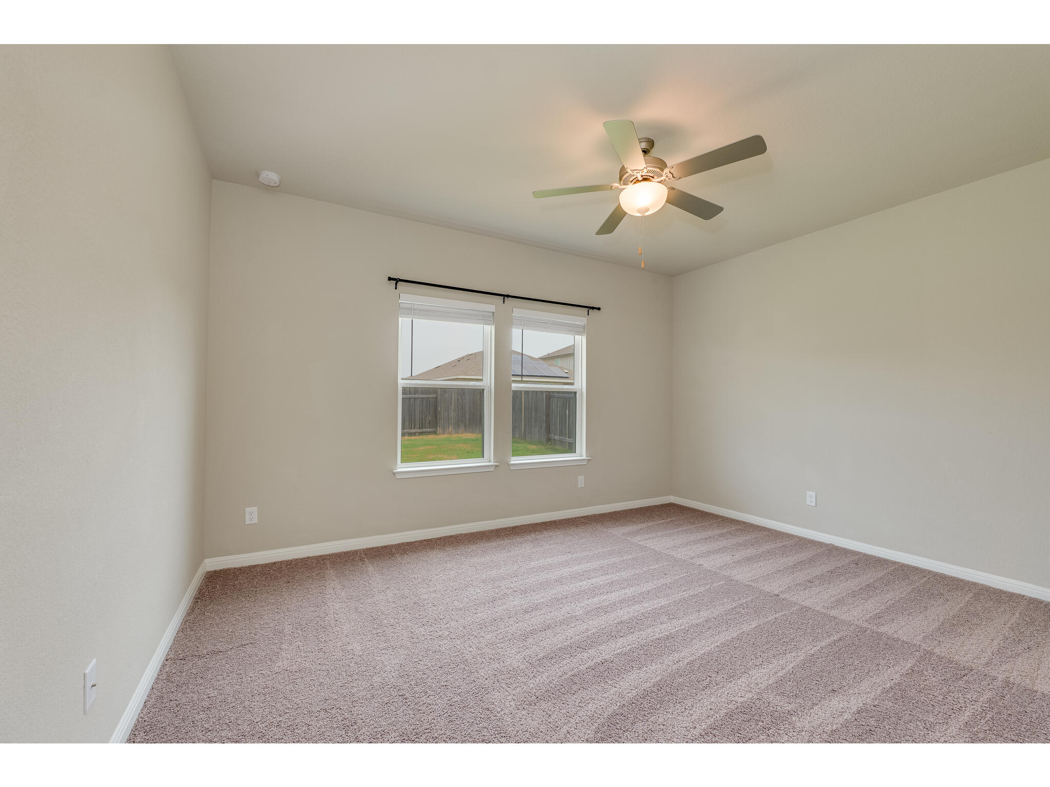 111 Grapefruit Road Hutto, TX 78634 - Photo 18 of 39 Spare room with carpet, a ceiling fan, baseboards, and a smoke detector
