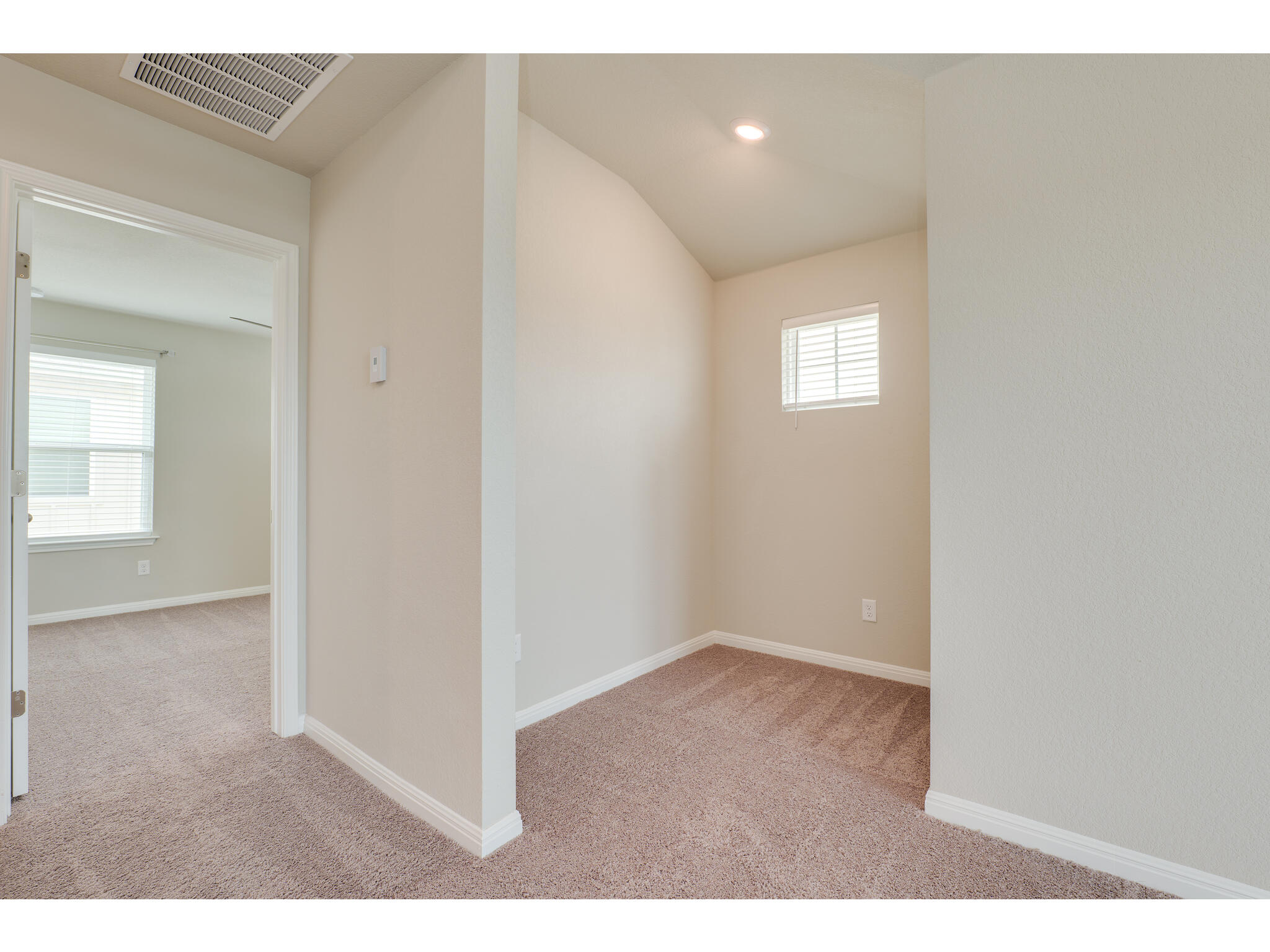 111 Grapefruit Road Hutto, TX 78634 - Photo 29 of 39 Empty room with carpet floors, baseboards, recessed lighting, and vaulted ceiling
