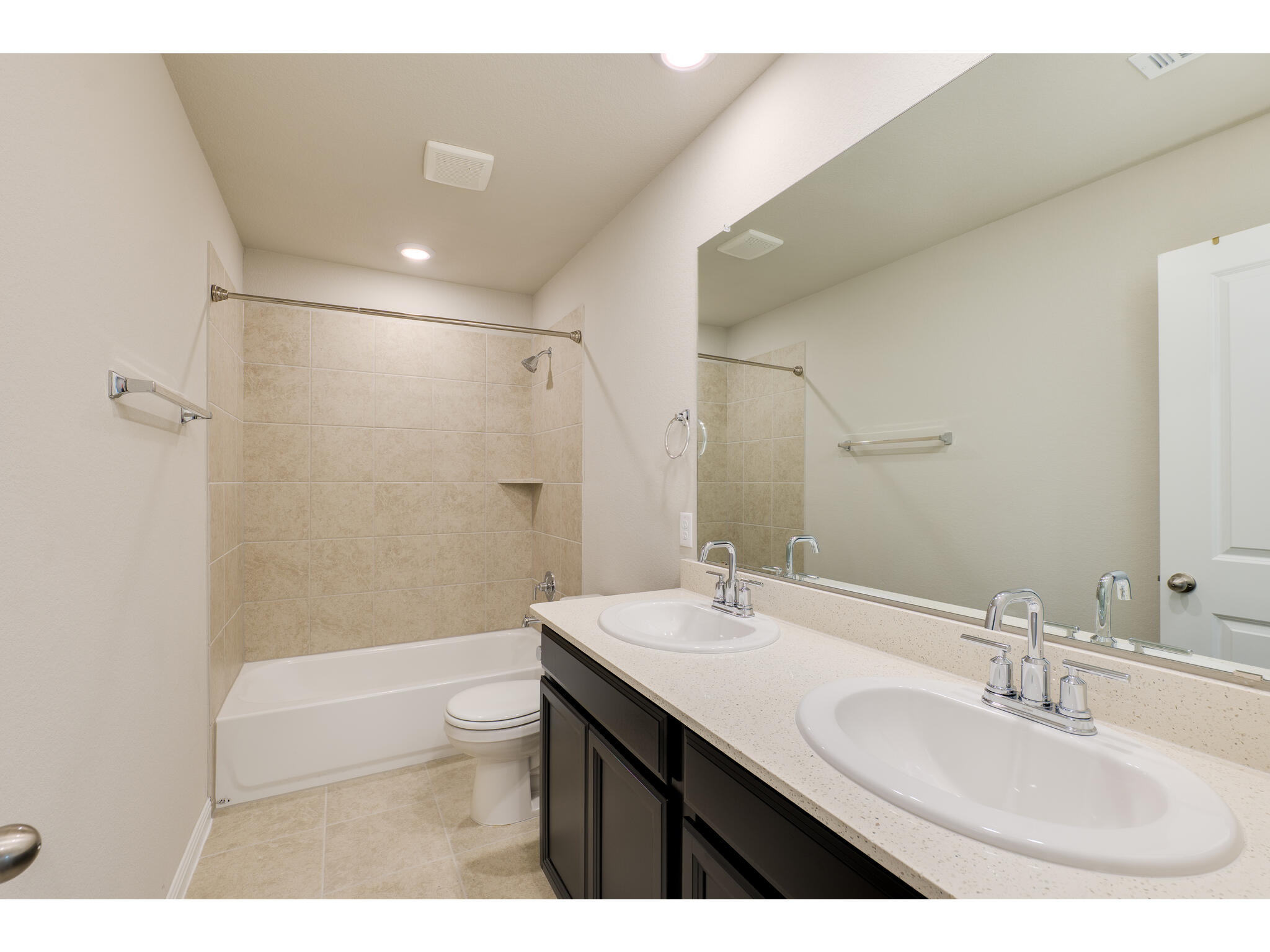 111 Grapefruit Road Hutto, TX 78634 - Photo 32 of 39 Bathroom featuring double vanity, toilet, shower combination, tile patterned floors, and recessed lighting