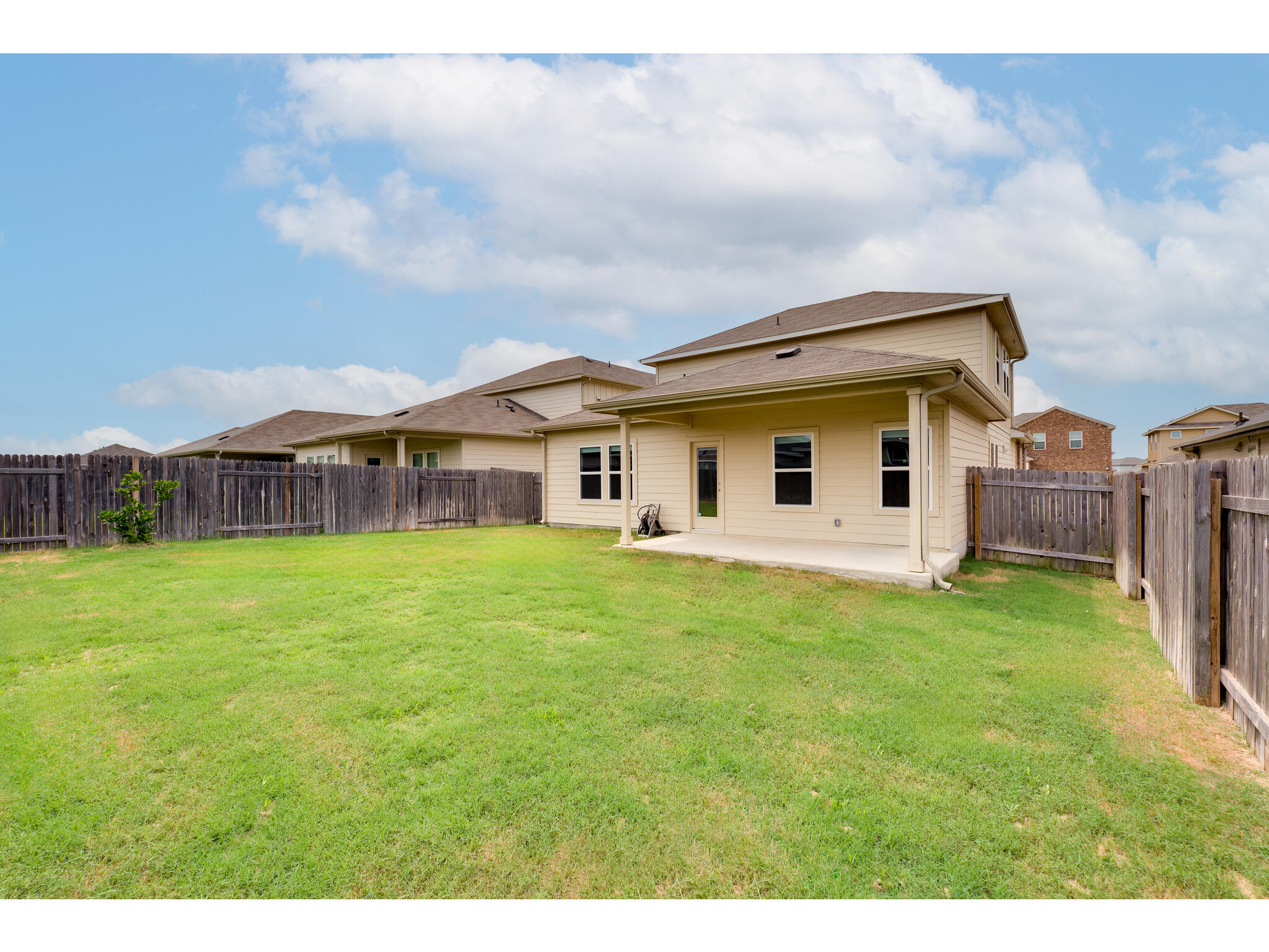 111 Grapefruit Road Hutto, TX 78634 - Photo 36 of 39 Rear view of house featuring a patio