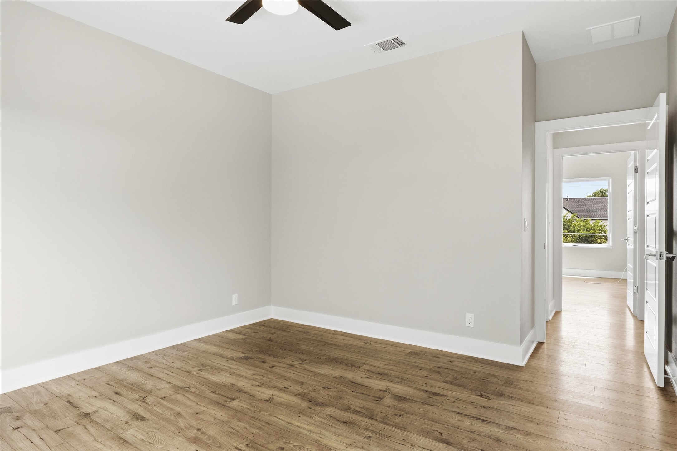 1210 Stobaugh Street, Unit B Austin, TX 78757 - Photo 10 of 40 A quiet space awaits, with durable wood flooring and ample natural light from the open doorway.