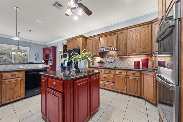a kitchen with stainless steel appliances granite countertop a sink and cabinets