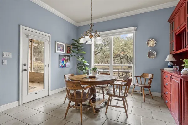 a dining room with furniture a chandelier and window