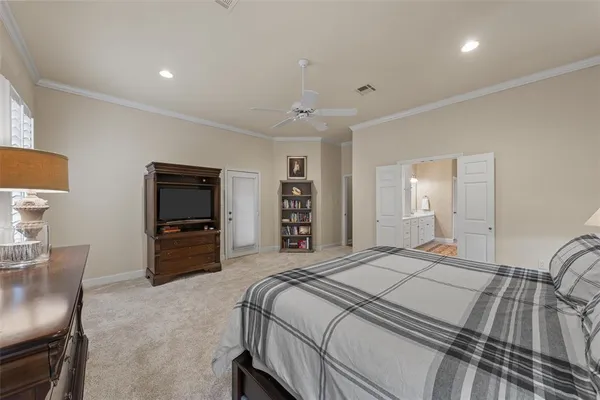 a bedroom with a bed and a television