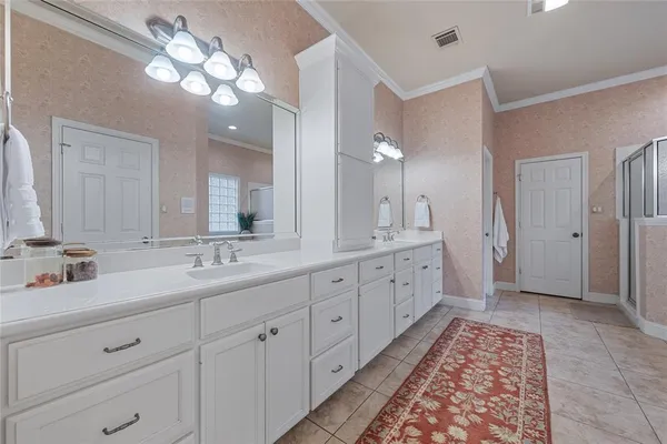 a bedroom with a bed a computer on a desk and chair