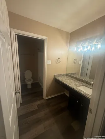 a bathroom with a sink a toilet and a mirror