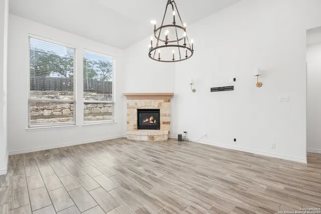 a view of empty room with window and fireplace