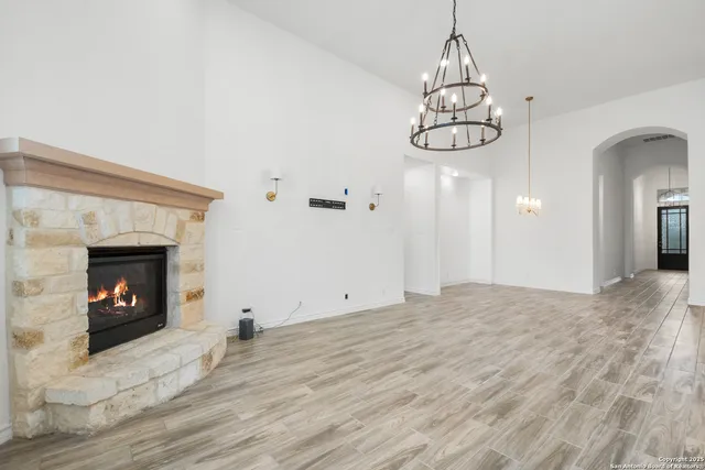 a view of empty room with wooden floor and fireplace