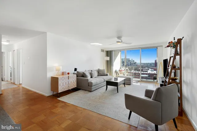 a living room with furniture a window and a view of kitchen