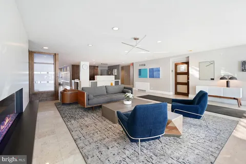 a living room with furniture and a dining table