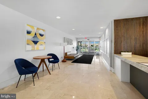 a view of a hallway with wooden floor and entryway